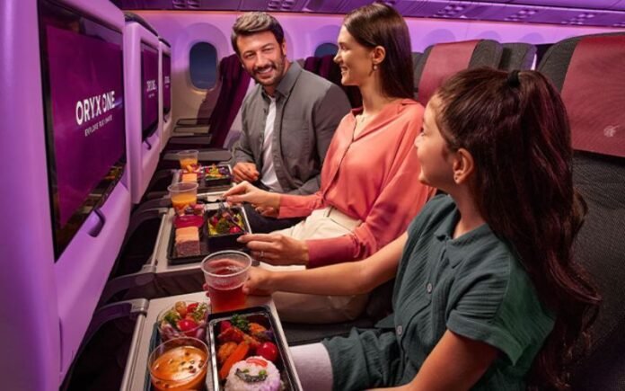 Qatar Airways Economy Class Cabin A family enjoying meals in Qatar Airways economy class with Oryx One entertainment screens
